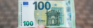 Hand holding 100 Euro