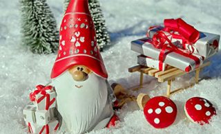 Christmas elf miniature figurine pulling a sledge